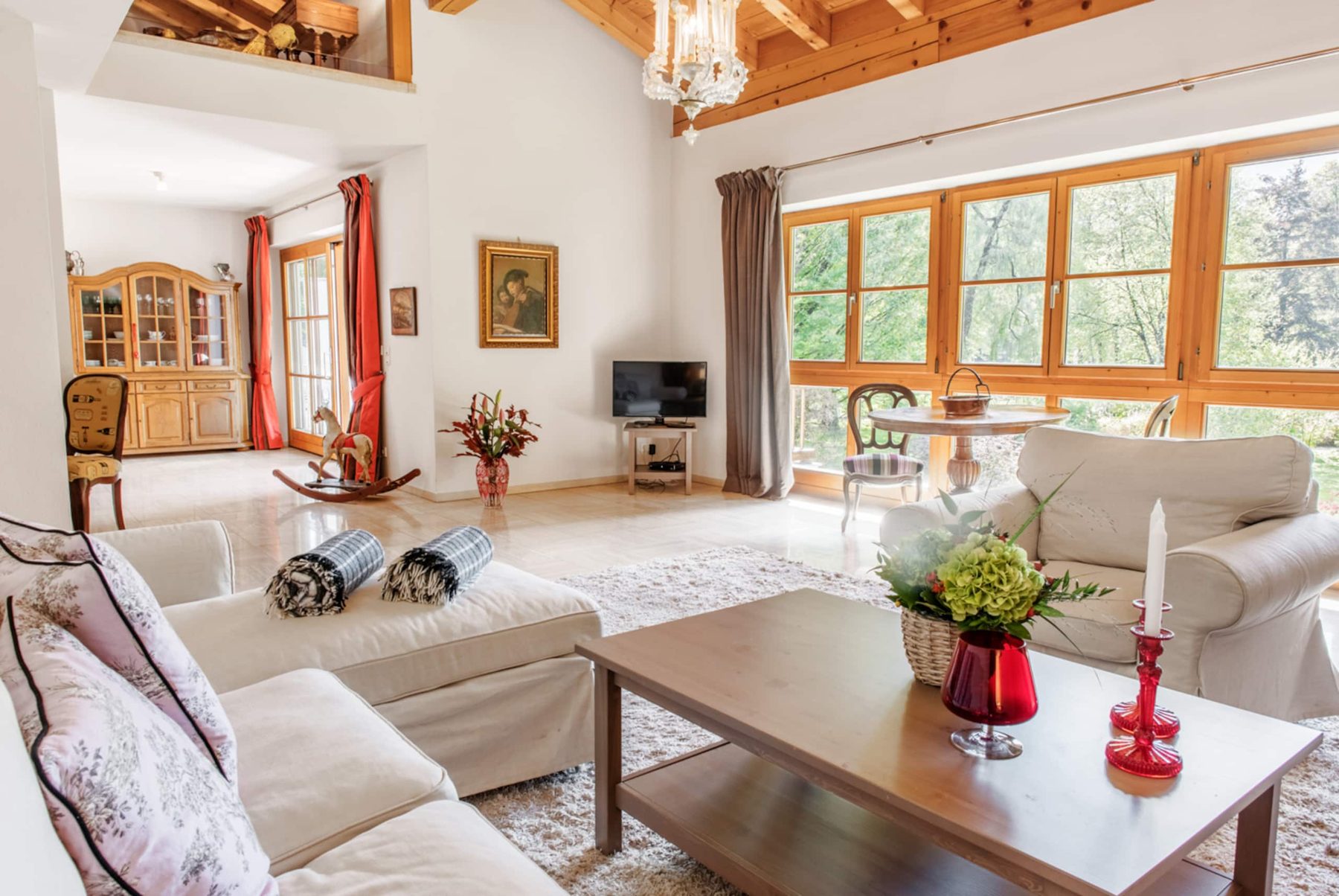 Living room with large windows and antique furniture